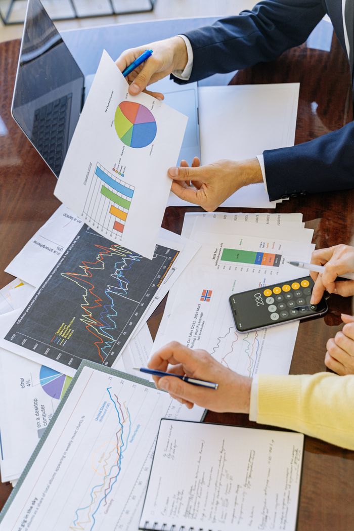 Crafting Captivating Headlines: Your awesome post title goes here Business professionals analyzing financial charts and graphs during a meeting.