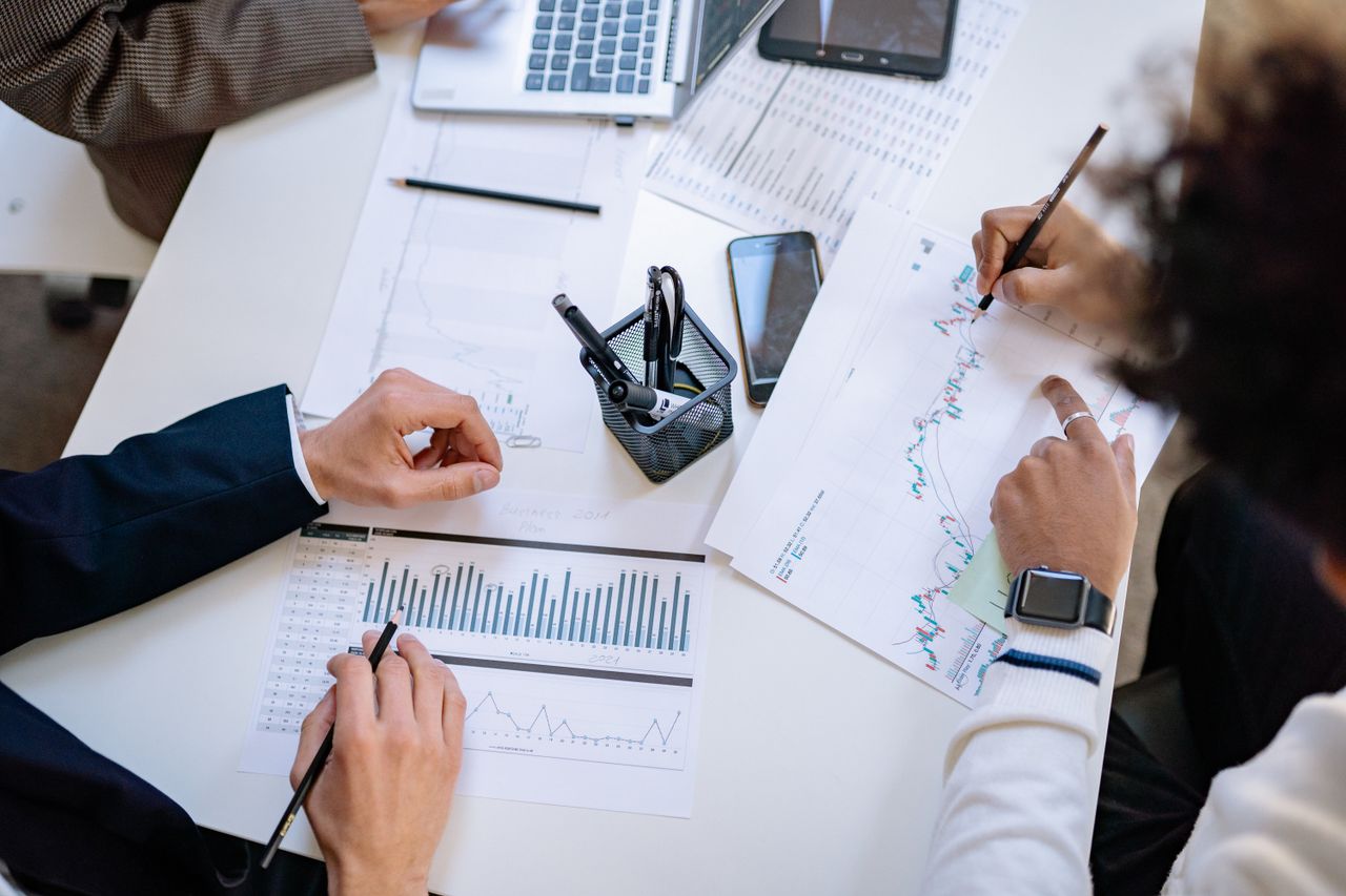 ours-journey Business team analyzing financial charts and graphs during a collaborative meeting.